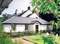 a view of Kilmichaels Vane Cottage in its garden