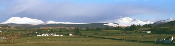 A panorama picture showing some of Arran's majestic mountains, covered in snow, from Kilpatrick