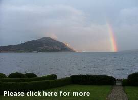 Holy Isle, a buddhist owned island guarding Lamlash Bay in a dramatic rainbow setting